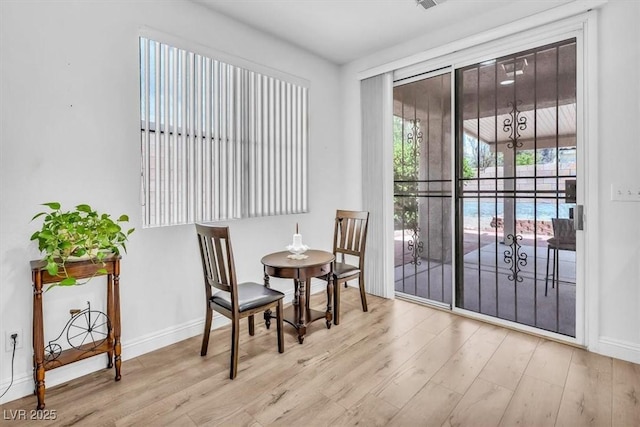 interior space with baseboards and wood finished floors