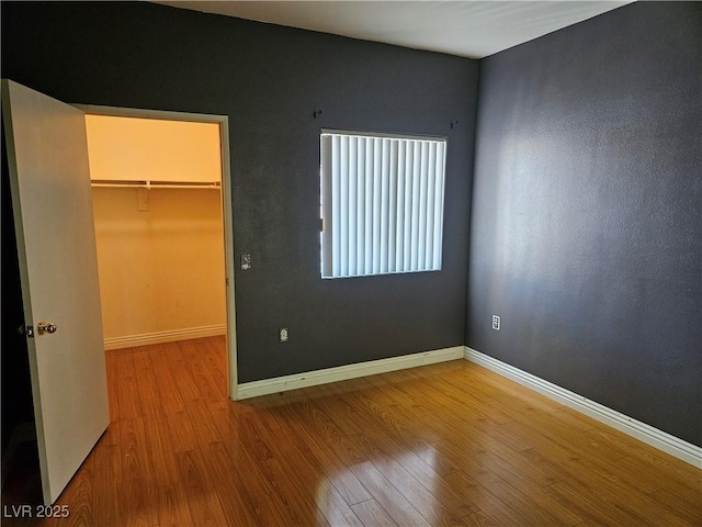 2615 W Gary Ave Unit 1085, Las Vegas, NV 89123 - unfurnished bedroom with a walk in closet, wood finished floors, and a closet