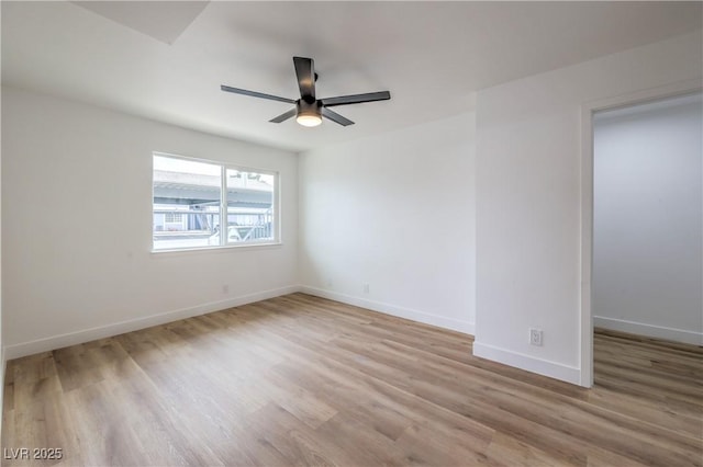unfurnished room featuring baseboards, ceiling fan, and wood finished floors