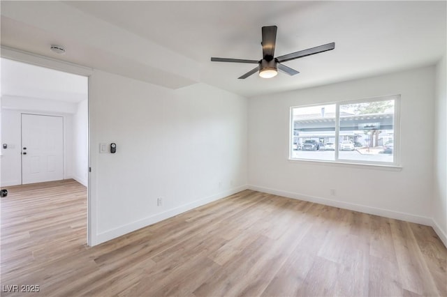 unfurnished room featuring baseboards, light wood finished floors, and ceiling fan