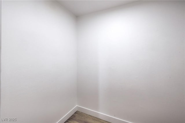 empty room featuring baseboards and light wood-type flooring