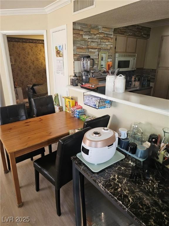 8101 W Flamingo Rd Unit 2078, Las Vegas, NV 89147 - dining area featuring ornamental molding and wood finished floors
