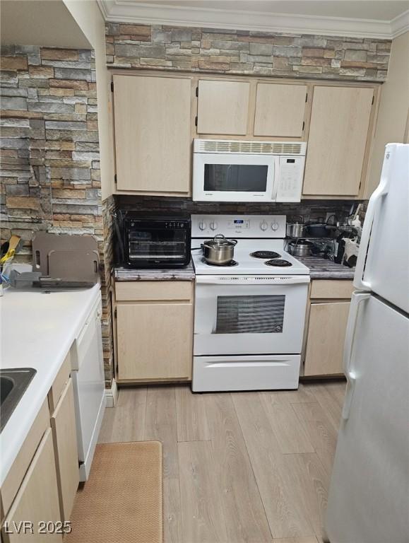 8101 W Flamingo Rd Unit 2078, Las Vegas, NV 89147 - kitchen with white appliances, ornamental molding, light brown cabinets, and light wood finished floors