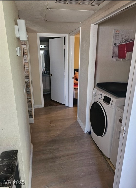 8101 W Flamingo Rd Unit 2078, Las Vegas, NV 89147 - laundry area with independent washer and dryer, wood finished floors, and baseboards