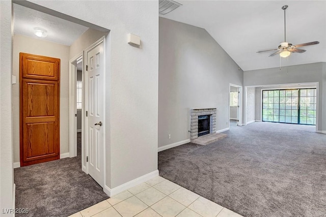 unfurnished living room with ceiling fan, visible vents, a brick fireplace, baseboards, and light carpet