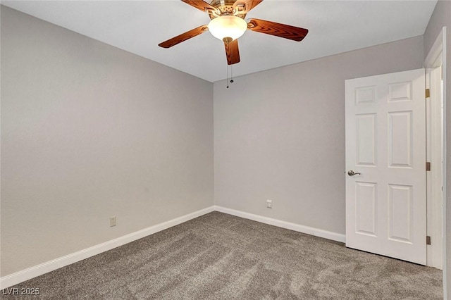 carpeted spare room with ceiling fan and baseboards
