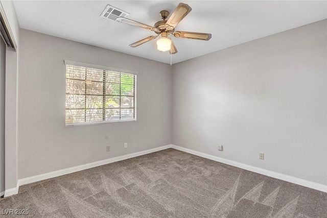 unfurnished room featuring carpet flooring, baseboards, visible vents, and ceiling fan