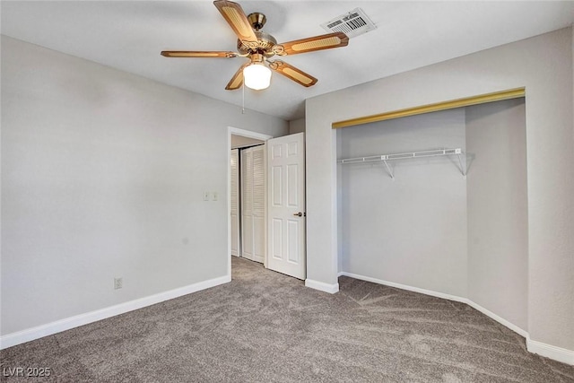 unfurnished bedroom featuring a ceiling fan, visible vents, baseboards, a closet, and carpet