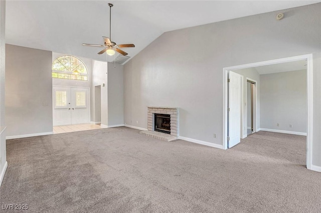 unfurnished living room featuring a brick fireplace, carpet, ceiling fan, and french doors