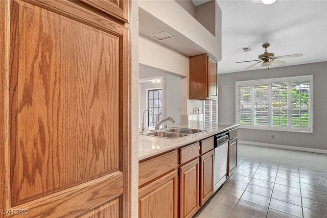 kitchen with visible vents, dishwasher, light countertops, baseboards, and a sink