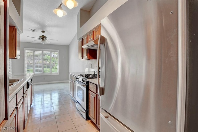 kitchen featuring a ceiling fan, visible vents, appliances with stainless steel finishes, light countertops, and under cabinet range hood