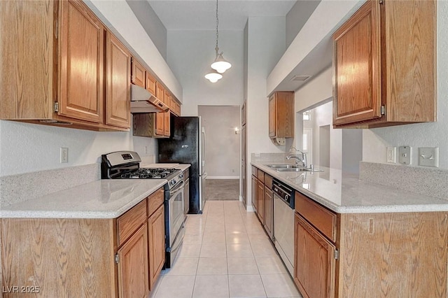 kitchen with a sink, light tile patterned floors, light countertops, under cabinet range hood, and stainless steel appliances