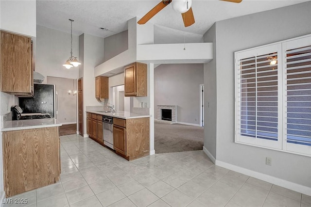 kitchen featuring brown cabinets, ceiling fan, dishwasher, light countertops, and light tile patterned floors
