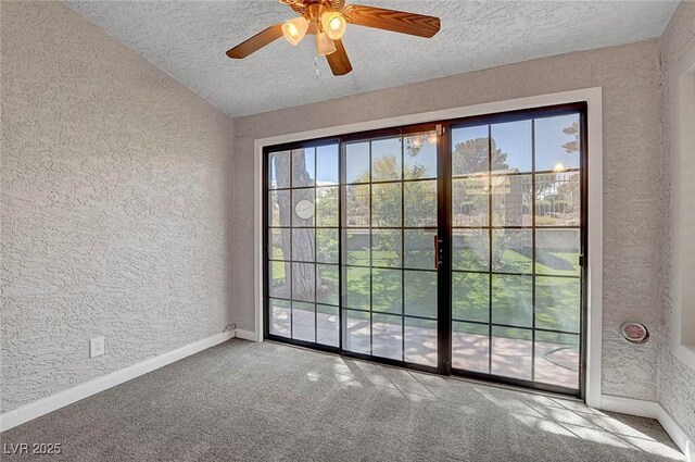 entryway with a textured ceiling, a textured wall, and plenty of natural light