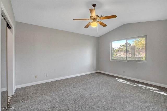 unfurnished bedroom with carpet floors, a ceiling fan, baseboards, vaulted ceiling, and a closet