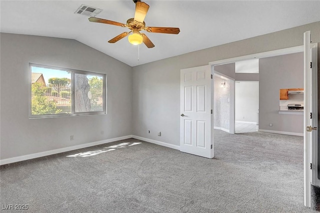 spare room with carpet, a ceiling fan, baseboards, lofted ceiling, and visible vents