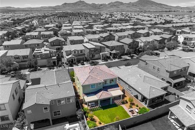 aerial view of residential area with a mountain backdrop and property boundaries highlighted