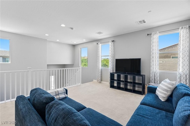 carpeted living room with recessed lighting and baseboards