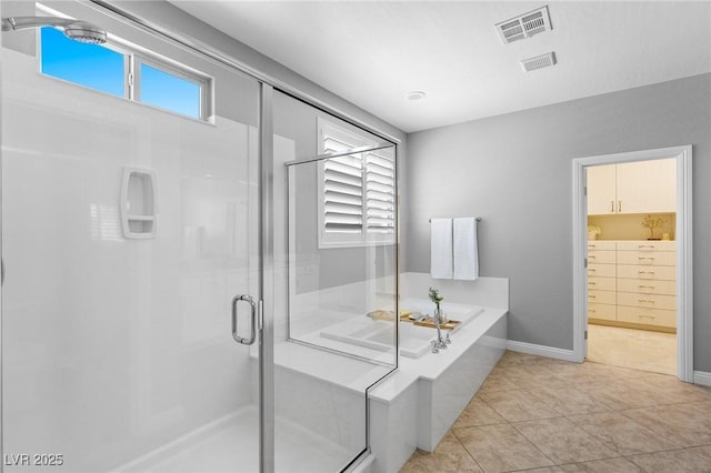 full bath with a shower stall, a garden tub, healthy amount of natural light, and tile patterned floors