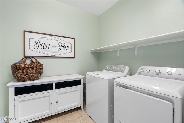 clothes washing area with washing machine and clothes dryer and cabinet space