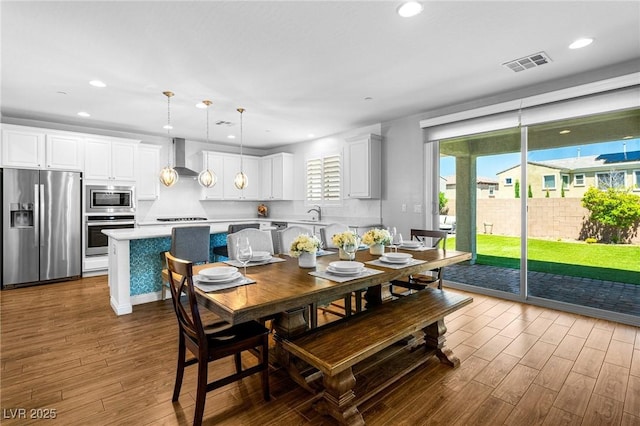 dining area with dark wood finished floors and recessed lighting