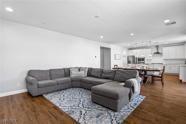 living room with dark wood finished floors, recessed lighting, and baseboards