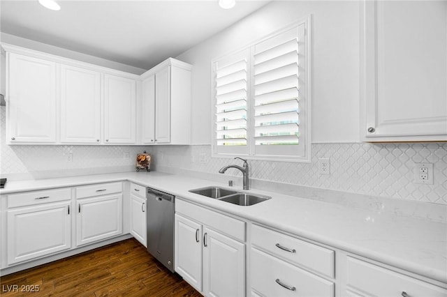 kitchen with a sink, stainless steel dishwasher, white cabinets, and tasteful backsplash