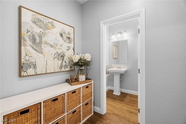 corridor with wood finished floors and baseboards