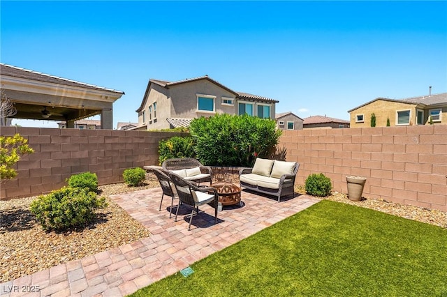 view of yard with a patio area, a ceiling fan, and an outdoor living space with a fire pit