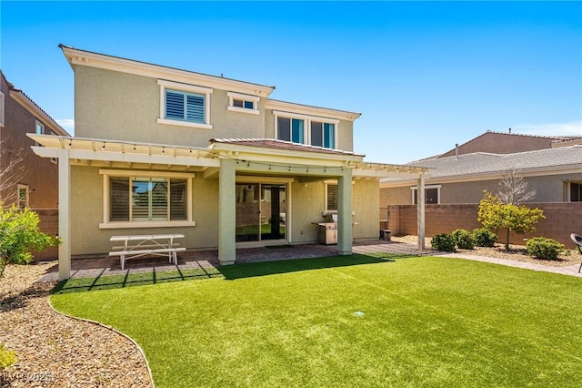 rear view of property featuring stucco siding and a patio