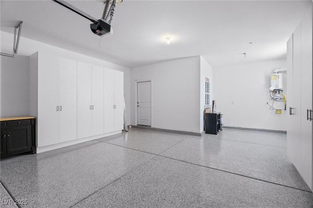 garage with a garage door opener, electric water heater, and baseboards