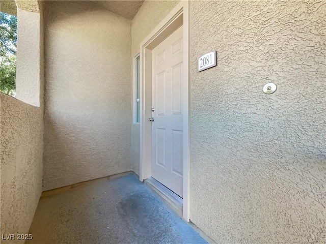 doorway to property with stucco siding
