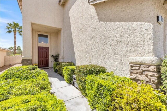 entrance to property with stucco siding