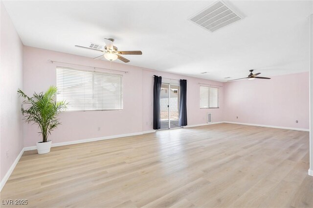spare room featuring visible vents, light wood-style flooring, and ceiling fan