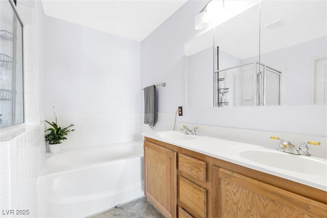 full bathroom featuring a garden tub, a sink, double vanity, and a shower stall