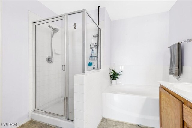 bathroom with a shower stall, a garden tub, and vanity