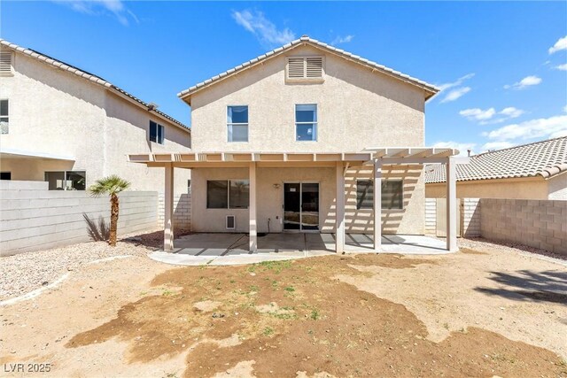 rear view of property featuring a patio, a fenced backyard, stucco siding, and a pergola