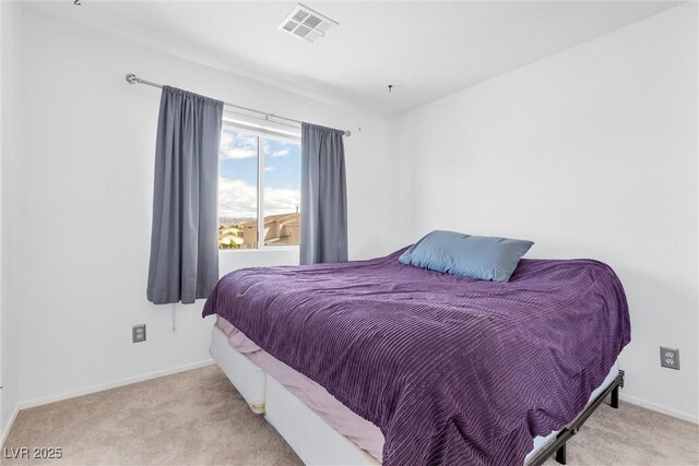 carpeted bedroom with baseboards and visible vents