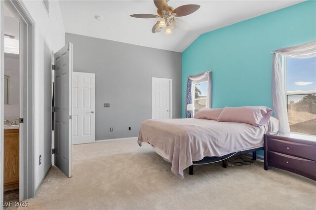 bedroom with light colored carpet, ceiling fan, vaulted ceiling, and a closet