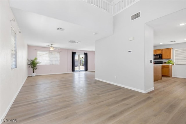 9013 Meisenheimer Ave, Las Vegas, NV 89143 - unfurnished living room with ceiling fan, light wood finished floors, and baseboards