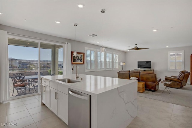 kitchen with visible vents, a kitchen island with sink, ceiling fan, a sink, and dishwasher