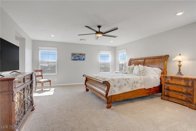 bedroom with baseboards, multiple windows, recessed lighting, and light colored carpet