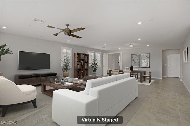 living area featuring ceiling fan, recessed lighting, and visible vents