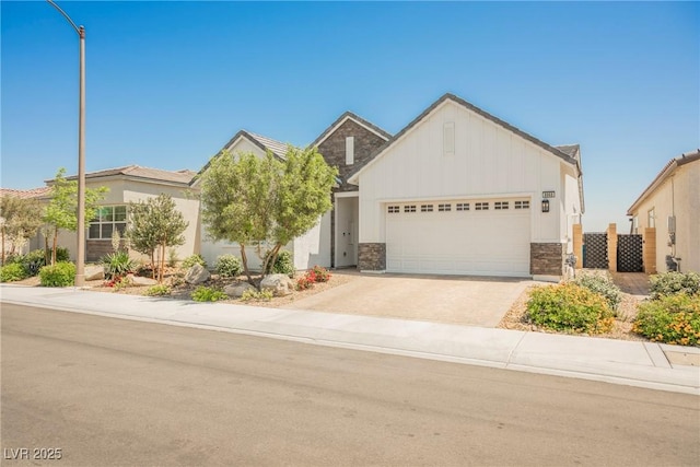 ranch-style home with a garage, board and batten siding, concrete driveway, and stone siding