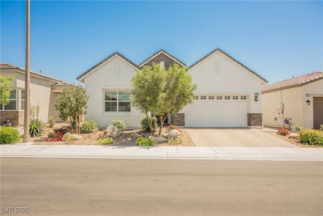 ranch-style home featuring board and batten siding, an attached garage, and driveway