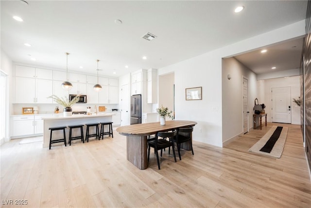dining area with visible vents, recessed lighting, and light wood-type flooring