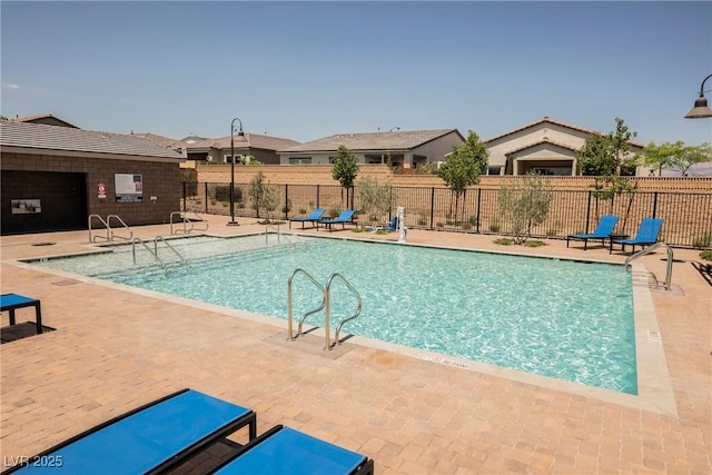 pool featuring a patio and fence