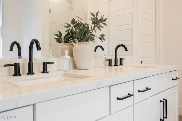 bathroom with a sink and double vanity