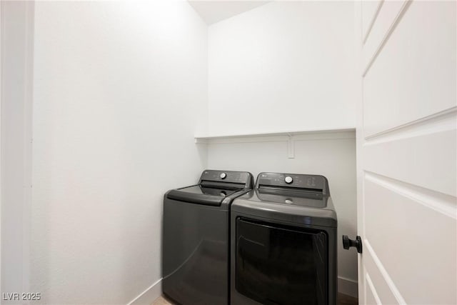 laundry room with laundry area, washer and clothes dryer, and baseboards