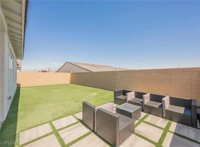view of yard featuring a patio, a fenced backyard, and an outdoor hangout area